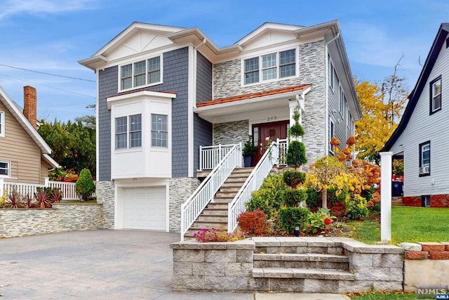 view of front of property featuring covered porch and a garage