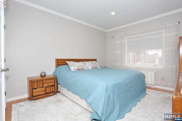 bedroom featuring wood-type flooring and crown molding