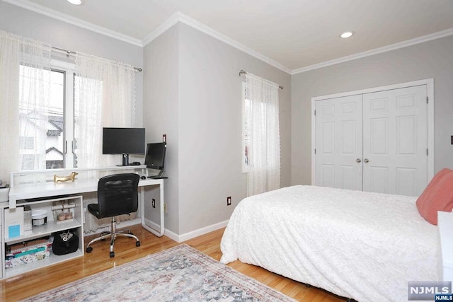 bedroom featuring a closet, ornamental molding, and light wood-type flooring