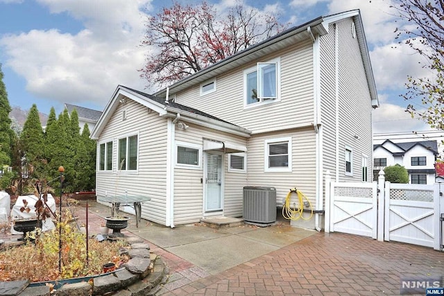 back of property with a patio and central air condition unit