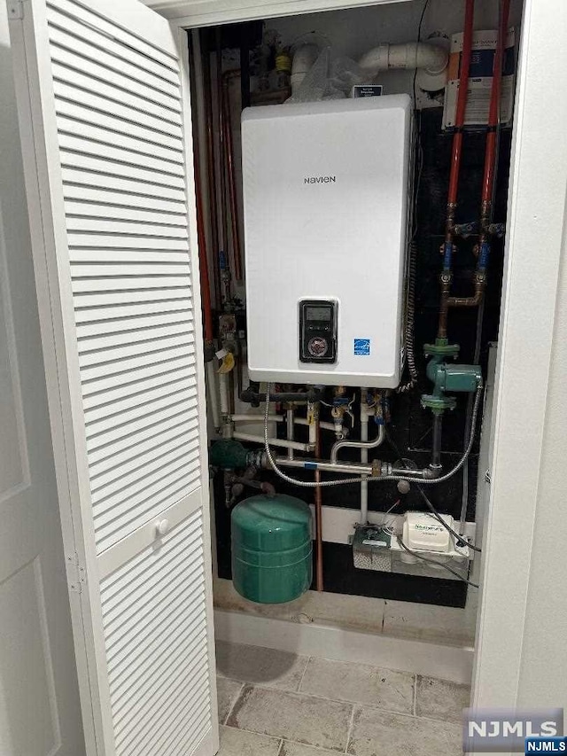 utility room with tankless water heater