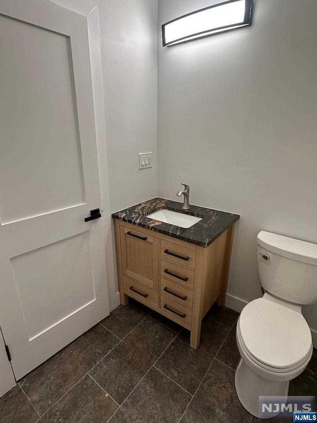 bathroom with tile patterned floors, vanity, and toilet