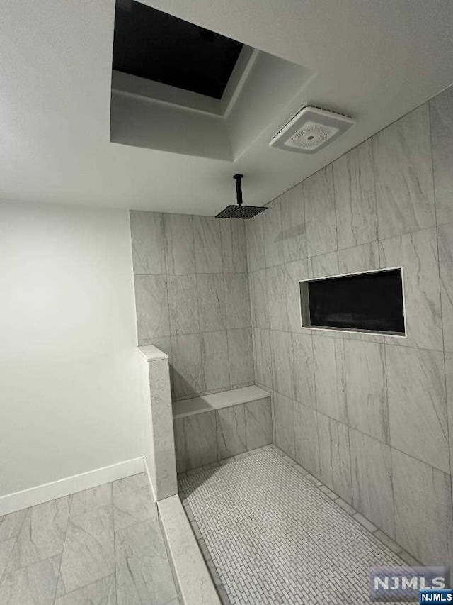 bathroom featuring a textured ceiling and walk in shower