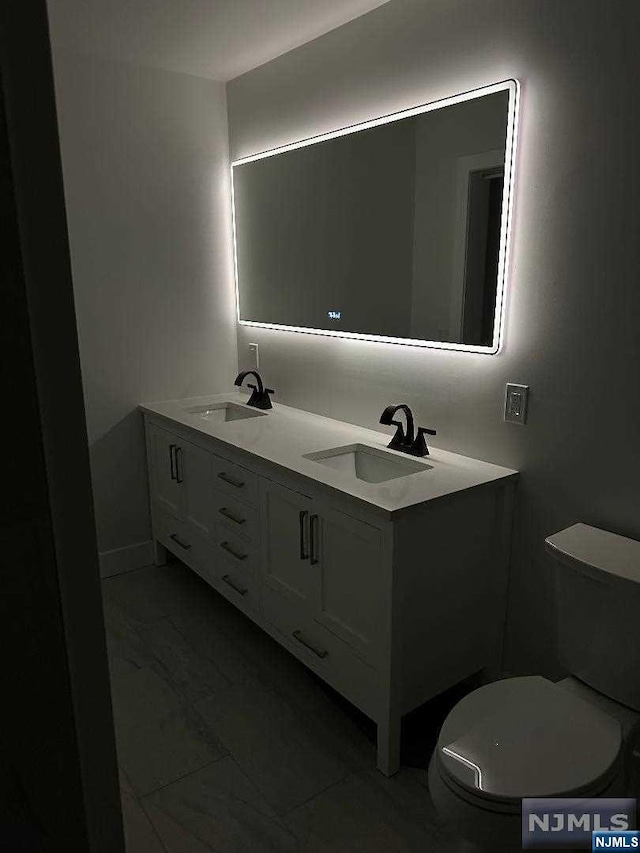 bathroom featuring vanity and toilet