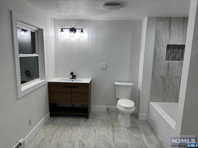 bathroom with a bath, vanity, toilet, and a baseboard heating unit