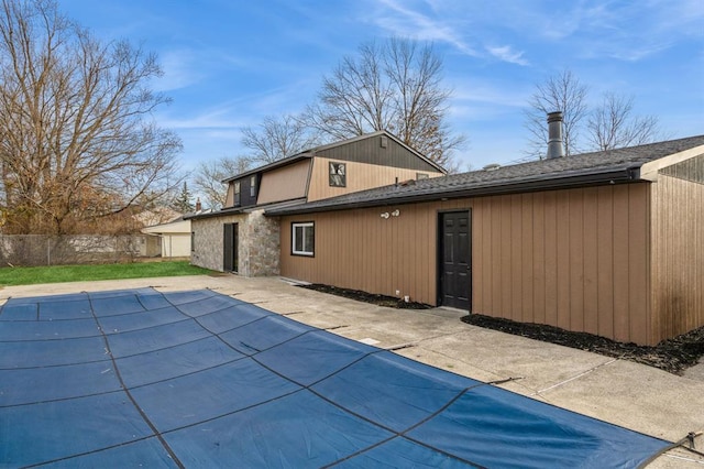 back of house featuring a patio area and a covered pool