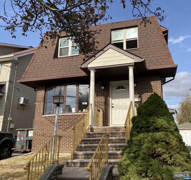 view of front of home with a wall mounted air conditioner