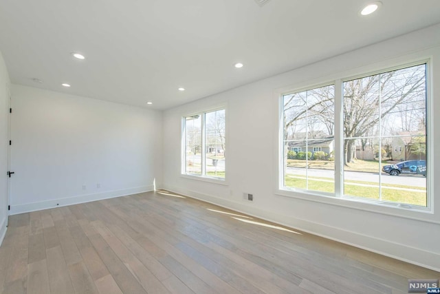 spare room with light hardwood / wood-style floors