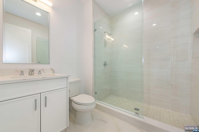 bathroom featuring vanity, toilet, and walk in shower