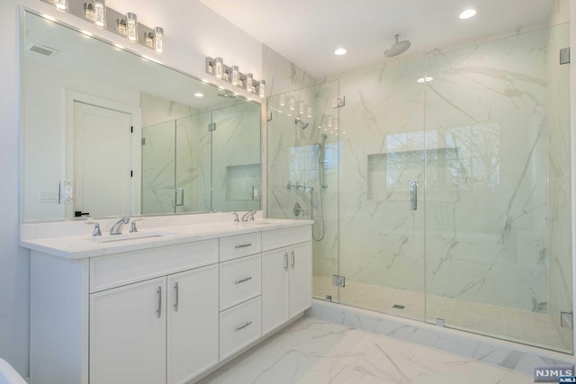 bathroom featuring vanity and an enclosed shower