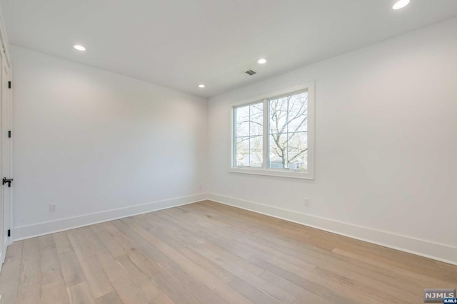 unfurnished room with light hardwood / wood-style flooring