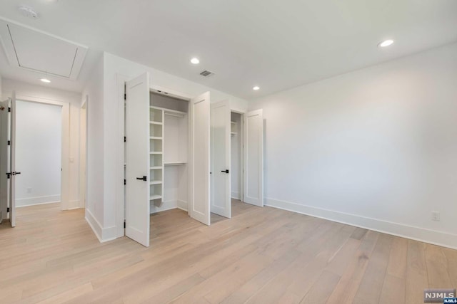 unfurnished bedroom featuring a closet and light hardwood / wood-style flooring