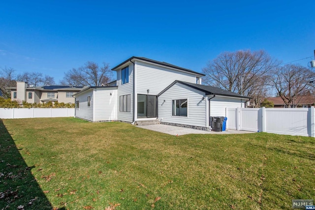 back of property featuring a patio area and a lawn