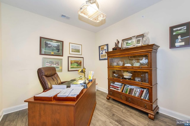 home office with wood-type flooring