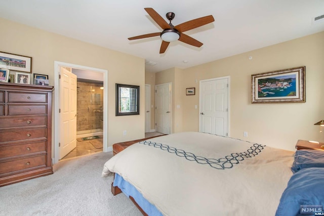 carpeted bedroom featuring ensuite bath and ceiling fan