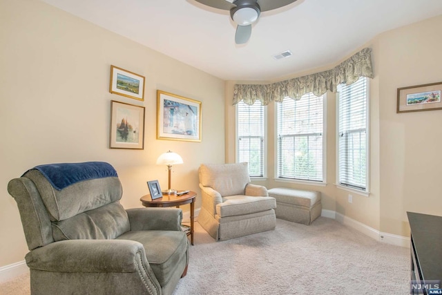 sitting room featuring carpet and ceiling fan