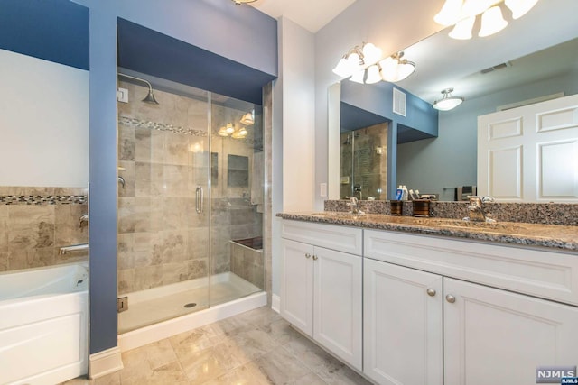 bathroom featuring shower with separate bathtub and vanity