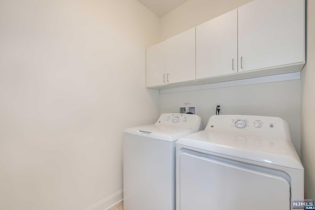 laundry area featuring cabinets and washing machine and dryer