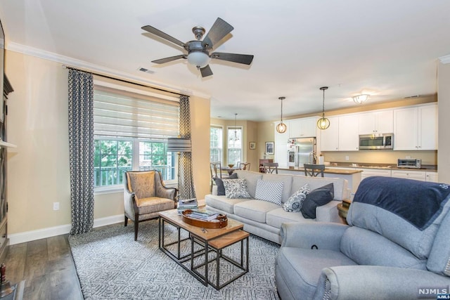 living room with ceiling fan, hardwood / wood-style floors, and ornamental molding