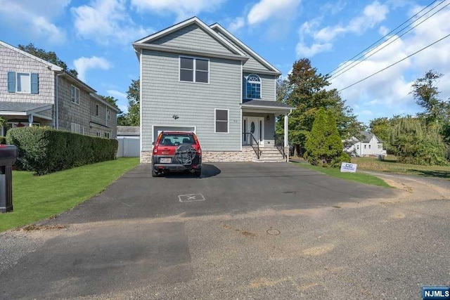 view of front of property with a front yard and a garage