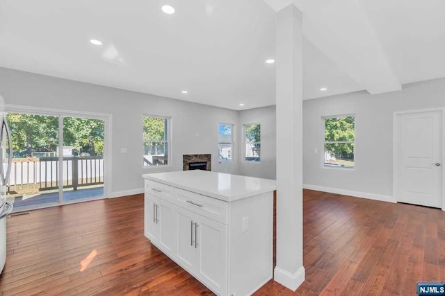 kitchen with white cabinets, plenty of natural light, and dark hardwood / wood-style flooring