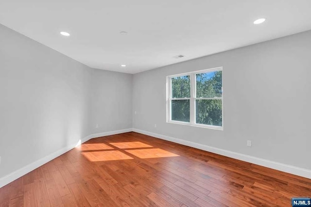 spare room with hardwood / wood-style flooring