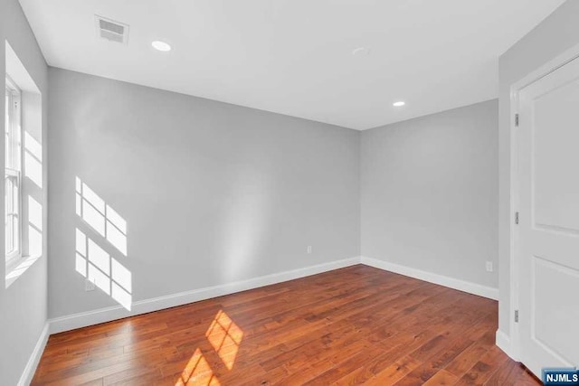 unfurnished room with hardwood / wood-style floors