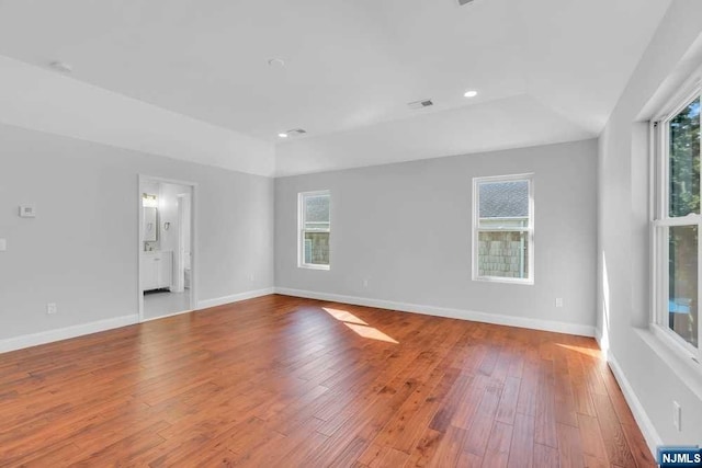 empty room with light wood-type flooring and plenty of natural light