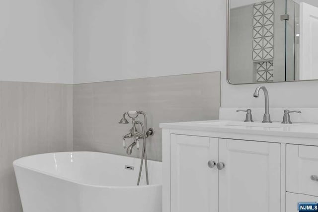 bathroom with a bathing tub and vanity