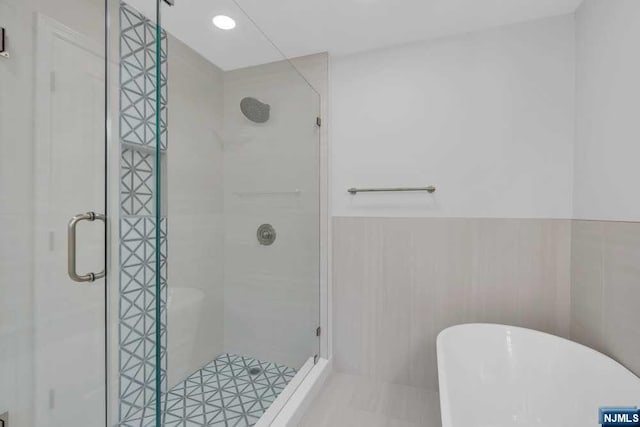 bathroom with separate shower and tub