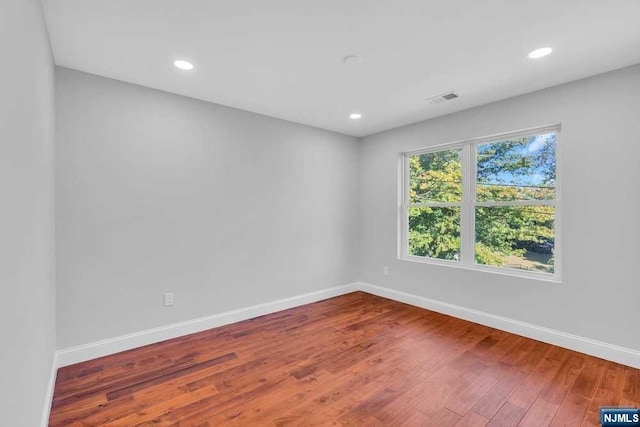 spare room featuring hardwood / wood-style flooring