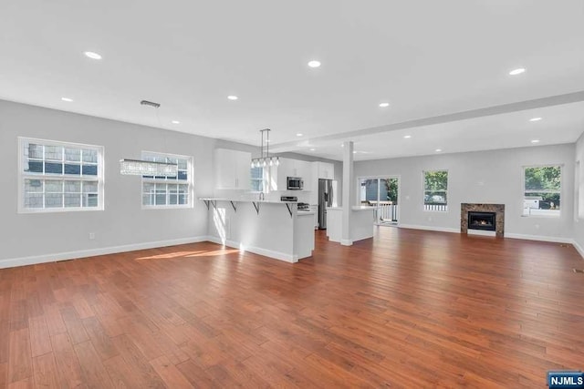 unfurnished living room featuring hardwood / wood-style flooring