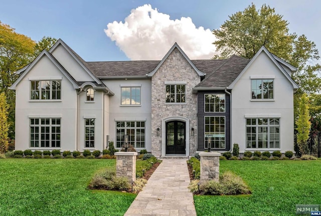 view of front facade with a front yard and french doors