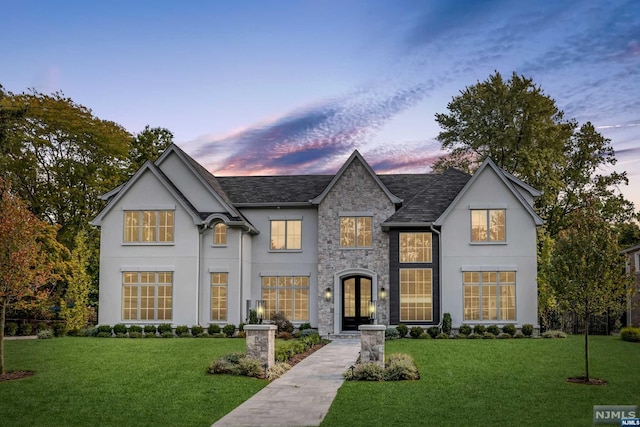 view of front of home featuring a yard and french doors