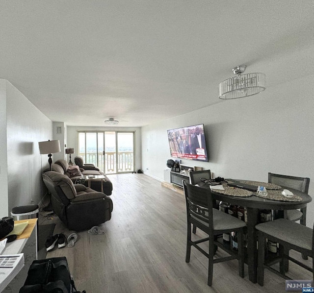 dining space with hardwood / wood-style flooring