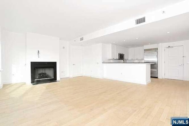 unfurnished living room featuring light wood-type flooring