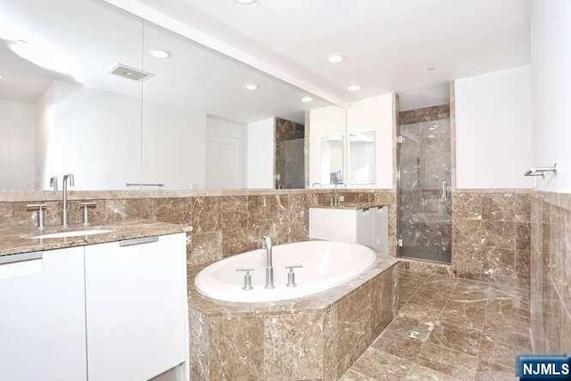 bathroom with shower with separate bathtub and vanity