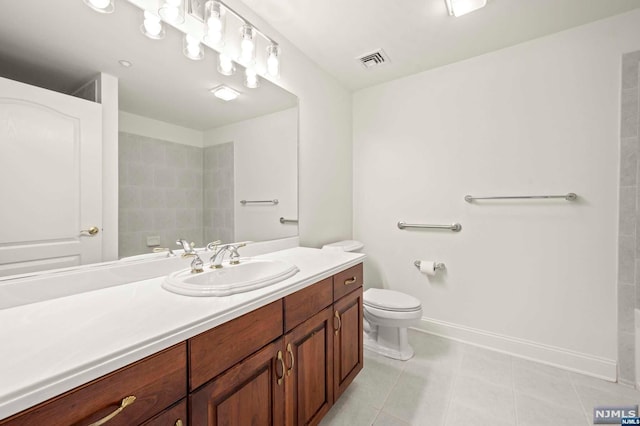 bathroom with tile patterned floors, vanity, and toilet