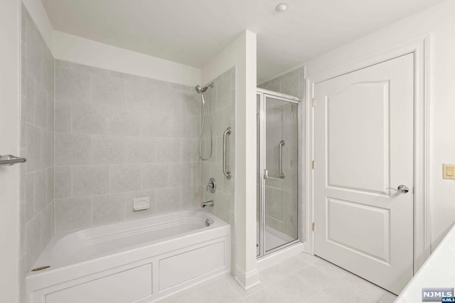 bathroom featuring tile patterned flooring and separate shower and tub