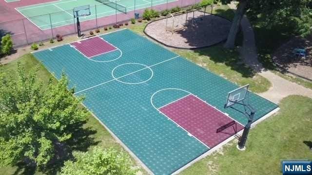 view of basketball court with a yard