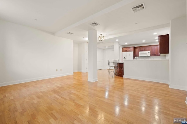 unfurnished living room with light wood-type flooring