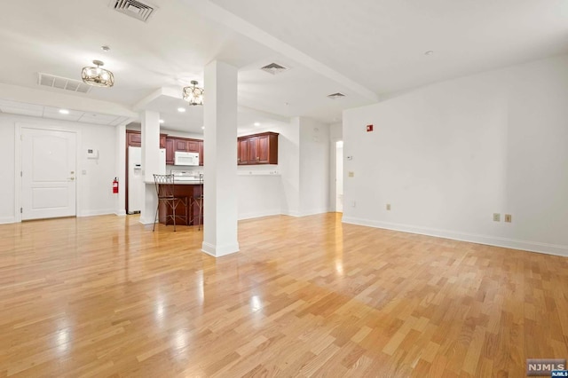 unfurnished living room with light wood-type flooring