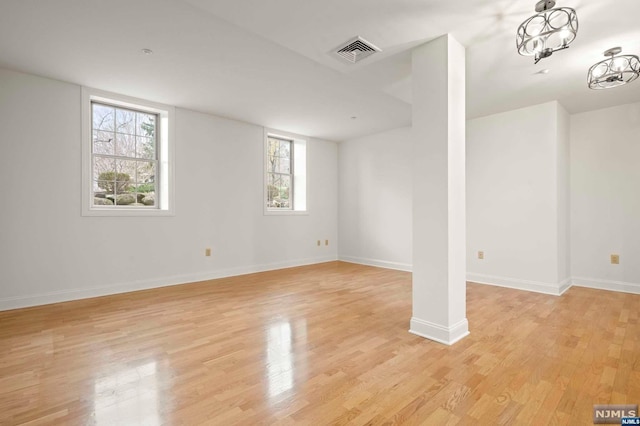 basement with a healthy amount of sunlight and light wood-type flooring