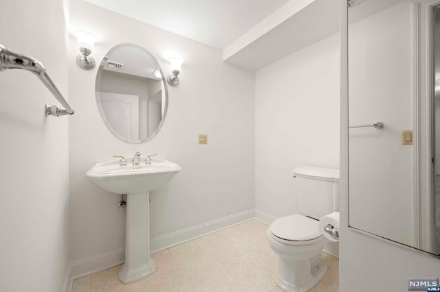 bathroom with tile patterned flooring and toilet