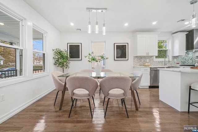 dining area with dark hardwood / wood-style floors