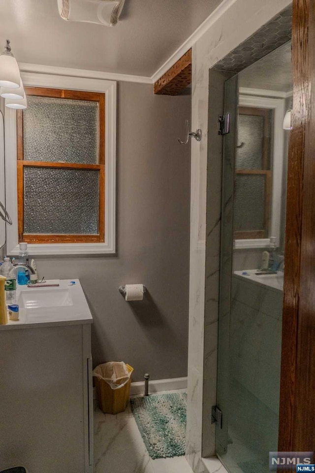 bathroom with vanity and a shower with shower door