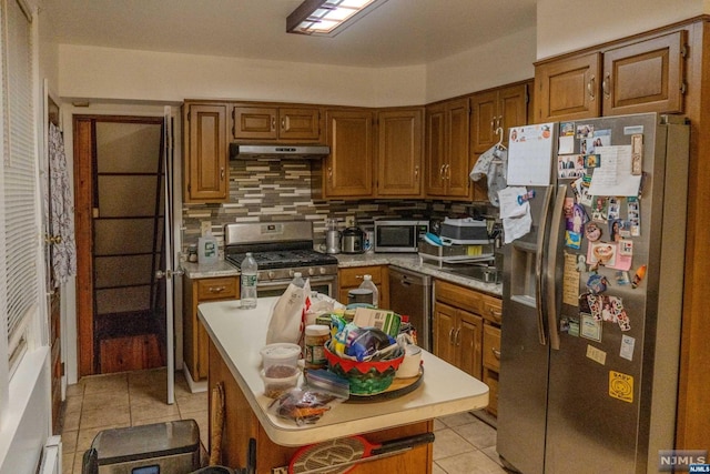 kitchen featuring sink, light tile patterned floors, backsplash, and appliances with stainless steel finishes