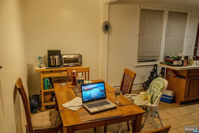 office area with light tile patterned floors and a baseboard radiator