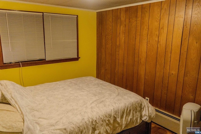 bedroom featuring crown molding and a baseboard radiator