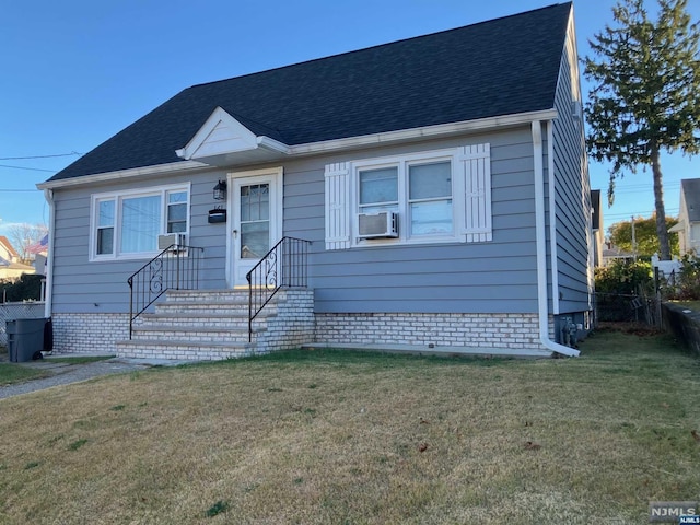 view of front of home with a front lawn and cooling unit